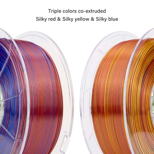 Two spools of triple-color 3D printer filament in silky red, yellow, and blue.