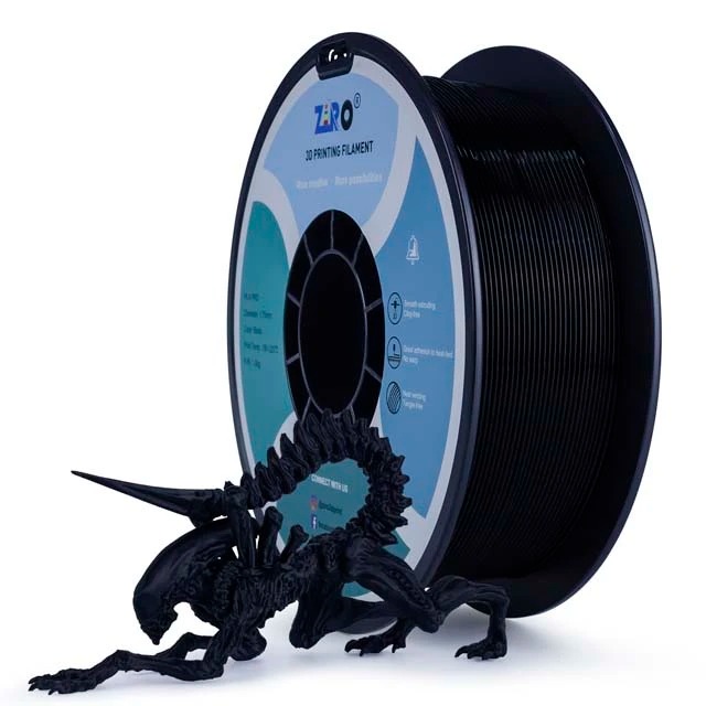 Black dragon figurine beside black 3D printer filament spool.