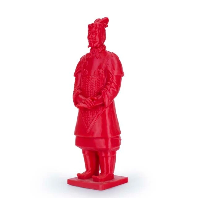Red statue resembling a traditional warrior figure.