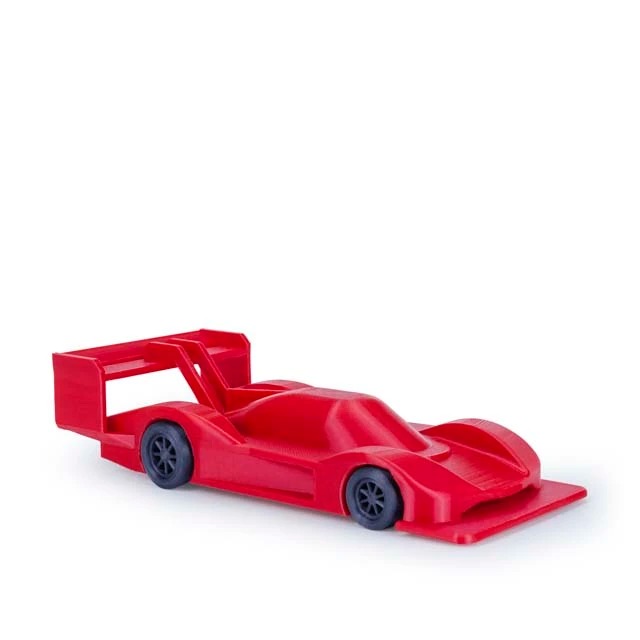 A sleek red race car toy with black wheels on a white background.