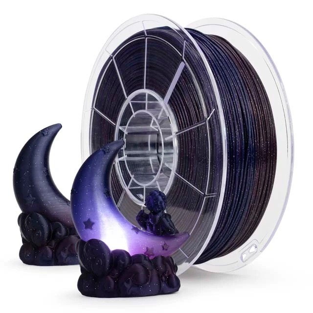 Black 3D printer filament spool with crescent moon and skull models.